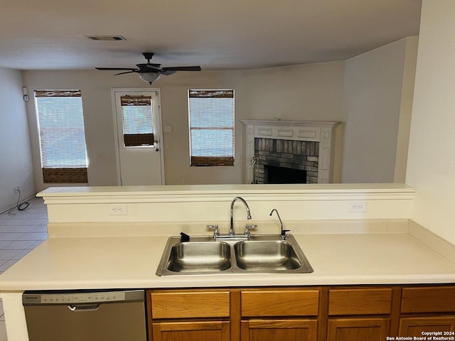 kitchen with a sink, visible vents, light countertops, brown cabinets, and dishwasher