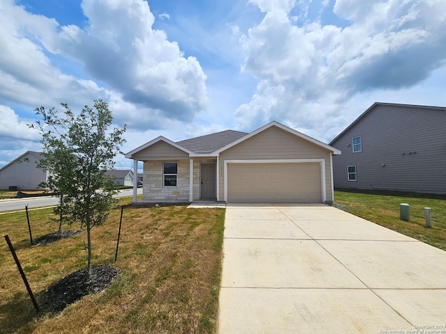 view of front of house featuring a garage and a front lawn