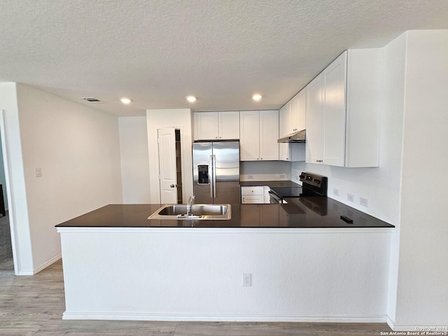 kitchen featuring white cabinetry, stainless steel fridge, electric range oven, a textured ceiling, and sink