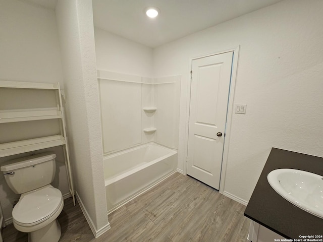 full bathroom with shower / bathing tub combination, wood-type flooring, toilet, and vanity