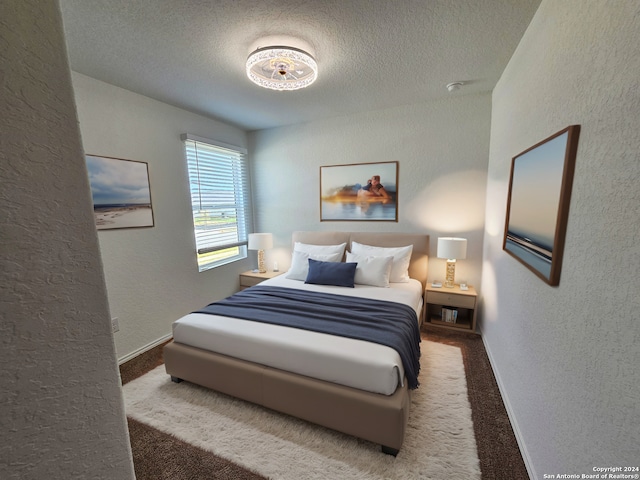 bedroom featuring carpet and a textured ceiling