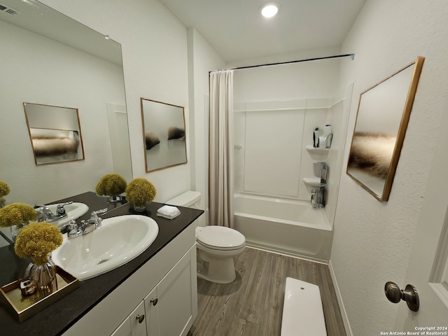 full bathroom with toilet, wood-type flooring, vanity, and shower / bath combo with shower curtain