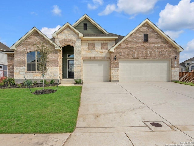 view of front facade featuring a garage, driveway, a front lawn, and brick siding