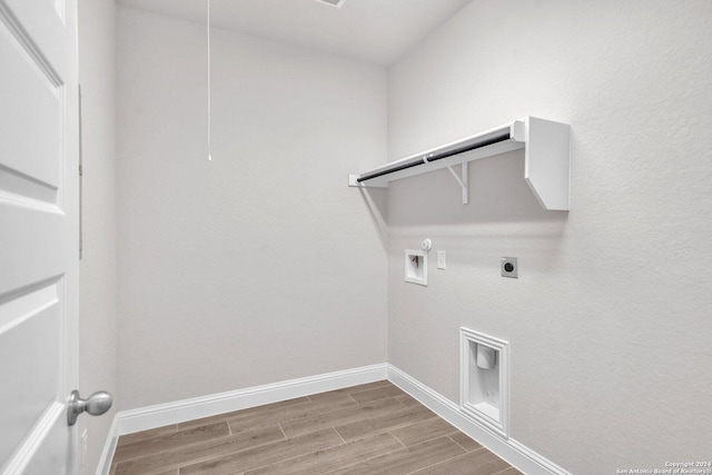213 Fillmore Fls, Cibolo, TX 78108 - laundry room with hookup for a gas dryer, electric dryer hookup, washer hookup, wood finished floors, and baseboards