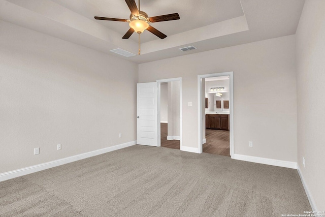 213 Fillmore Fls, Cibolo, TX 78108 - unfurnished bedroom with carpet floors, a raised ceiling, ensuite bathroom, baseboards, and ceiling fan