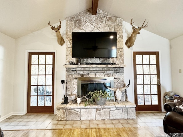 living room with tile patterned flooring, a fireplace, and vaulted ceiling with beams