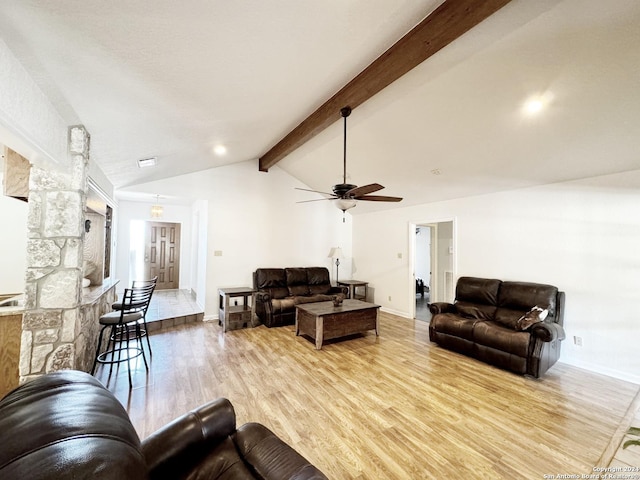 living room with ceiling fan, light hardwood / wood-style flooring, and lofted ceiling with beams