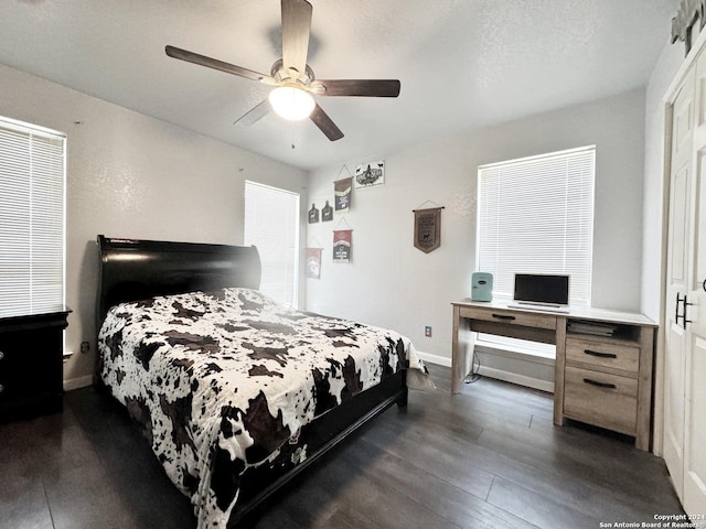 bedroom featuring a textured ceiling, ceiling fan, and dark hardwood / wood-style flooring