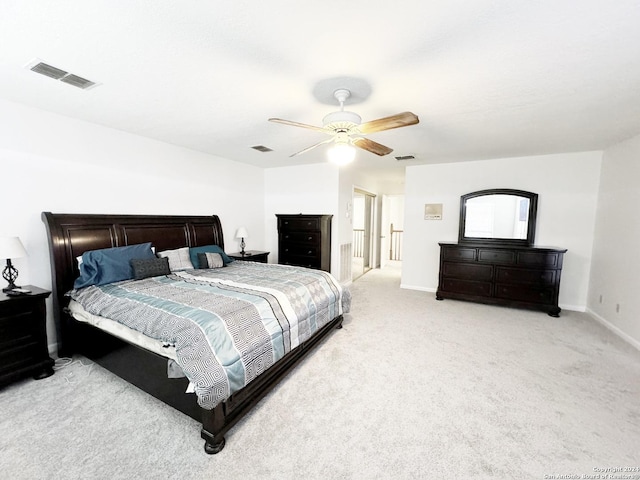 bedroom featuring ceiling fan and light carpet