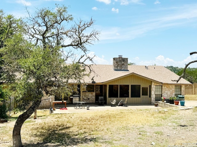 back of house with a lawn and a patio area