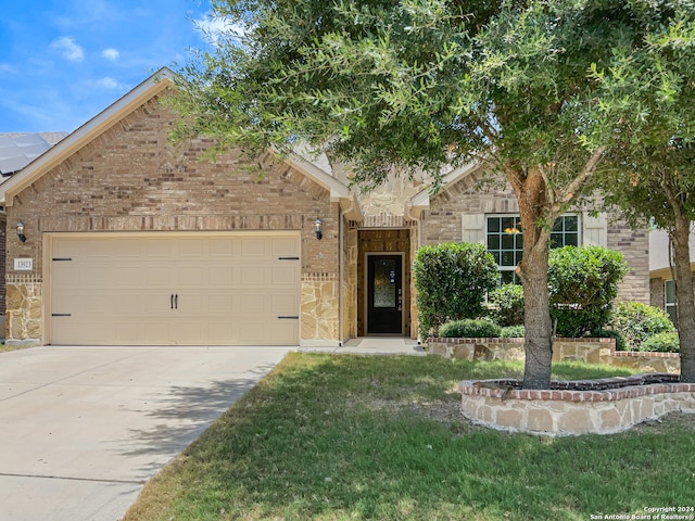 view of front of home with a garage and a front lawn