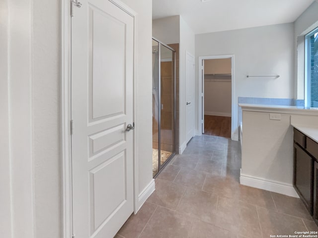 bathroom with vanity, tile patterned floors, and walk in shower