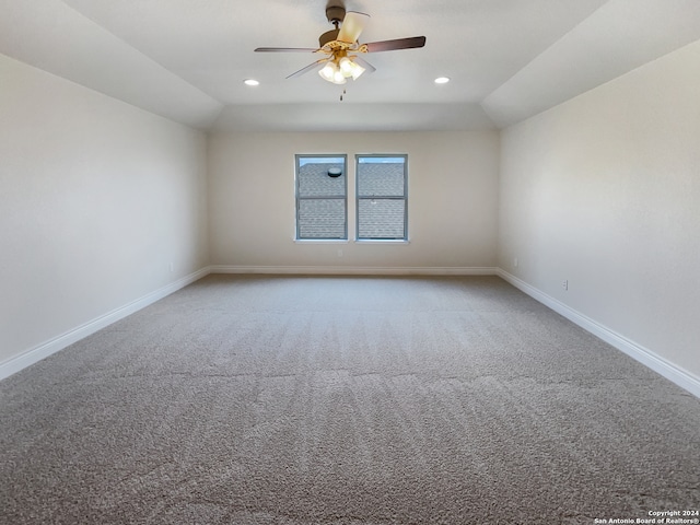 carpeted empty room with lofted ceiling and ceiling fan