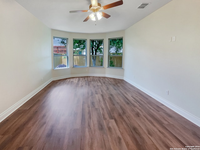 spare room featuring dark hardwood / wood-style flooring and ceiling fan