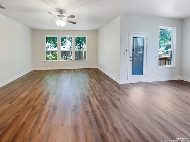 spare room featuring hardwood / wood-style flooring and a healthy amount of sunlight