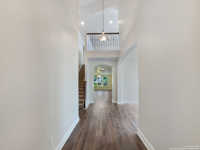 corridor featuring dark hardwood / wood-style floors and a high ceiling