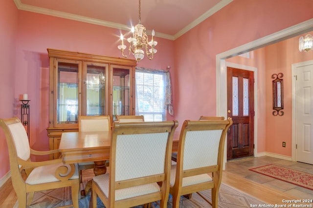 dining room featuring crown molding, tile patterned flooring, and a notable chandelier