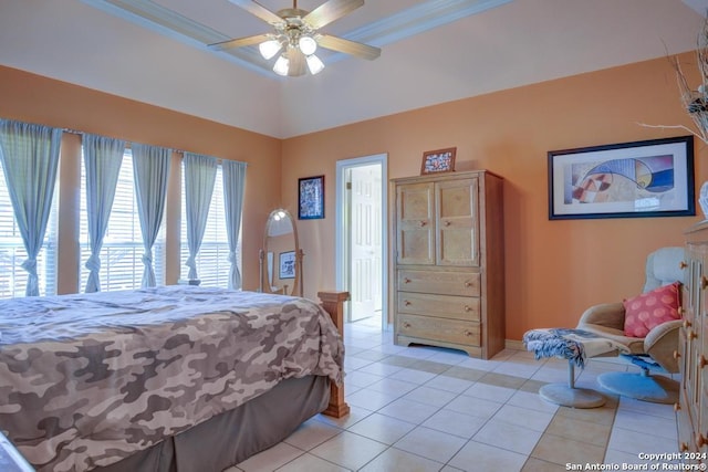 bedroom featuring light tile patterned floors, crown molding, a ceiling fan, and baseboards