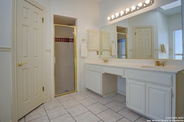 bathroom featuring double vanity, an enclosed shower, and tile patterned flooring