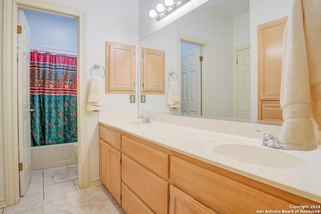 bathroom with shower / tub combo, tile patterned floors, and dual bowl vanity