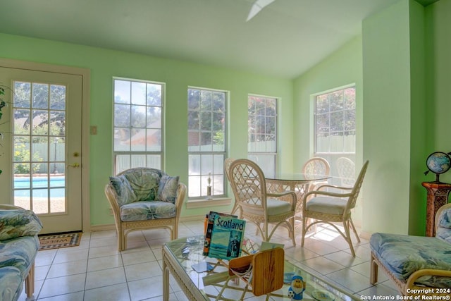 sunroom featuring plenty of natural light and vaulted ceiling