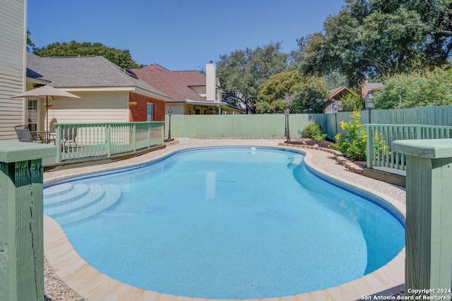view of pool with a deck, a fenced backyard, and a fenced in pool