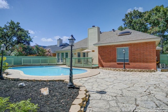 view of swimming pool featuring fence, a patio, and a fenced in pool