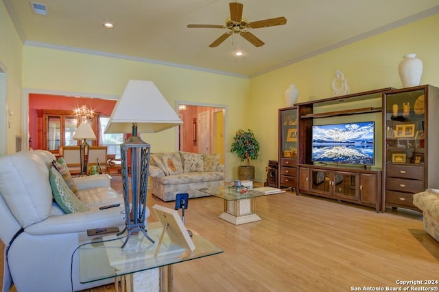 living room featuring visible vents, ceiling fan, light wood finished floors, and crown molding