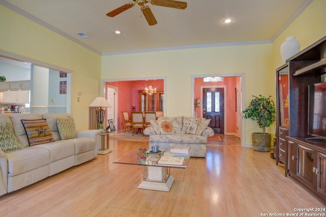 living room featuring ornamental molding, light wood finished floors, visible vents, and ceiling fan with notable chandelier