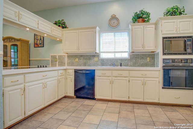 kitchen featuring decorative backsplash, tile counters, black appliances, and light tile patterned floors