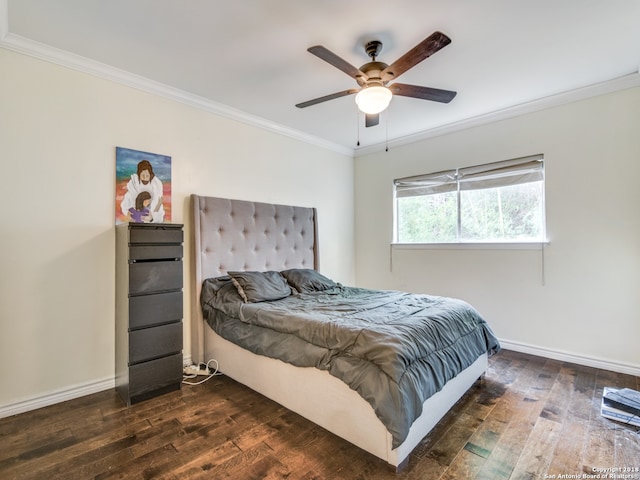 bedroom with crown molding, dark hardwood / wood-style flooring, and ceiling fan