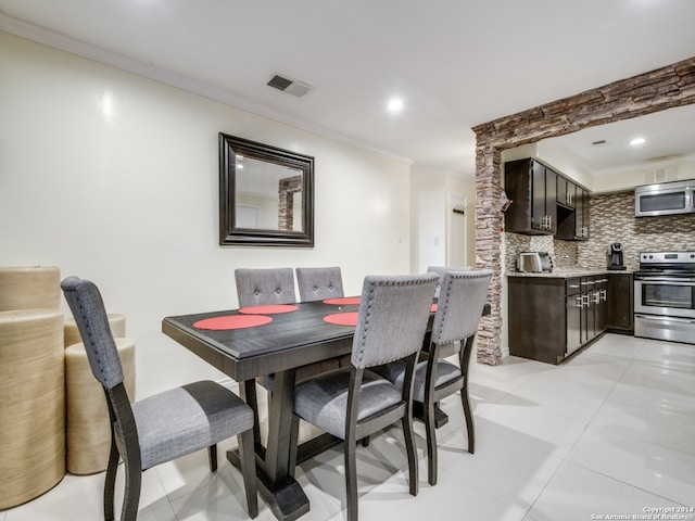 tiled dining room with ornamental molding