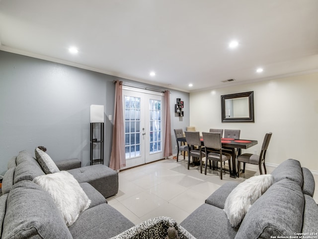 living room with light tile patterned flooring, crown molding, and french doors