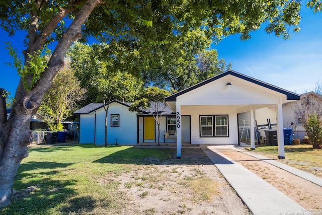 ranch-style house with covered porch and a front lawn