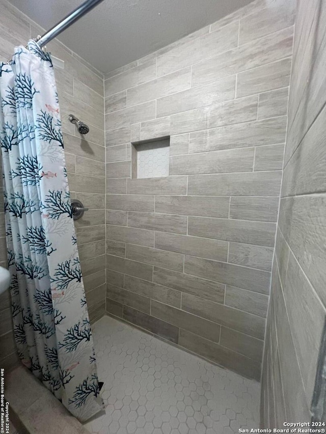 bathroom featuring a shower with curtain