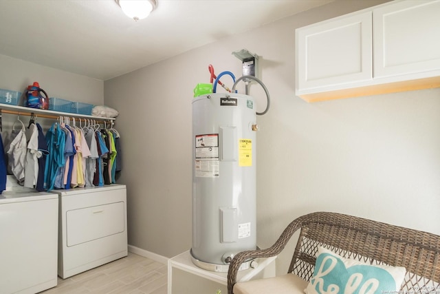 laundry area featuring cabinet space, baseboards, electric water heater, light wood-style floors, and separate washer and dryer