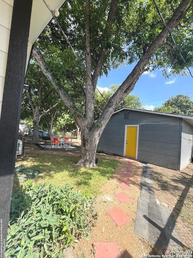 view of yard featuring a patio area and an outbuilding