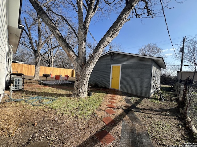 view of outbuilding with a fenced backyard and an outdoor structure