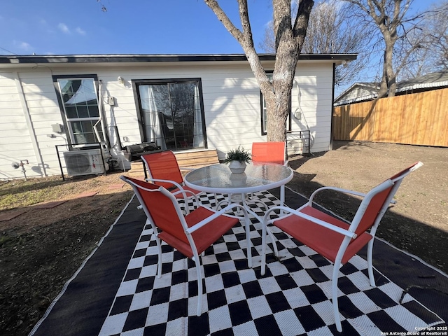 view of patio with fence, cooling unit, and outdoor dining space