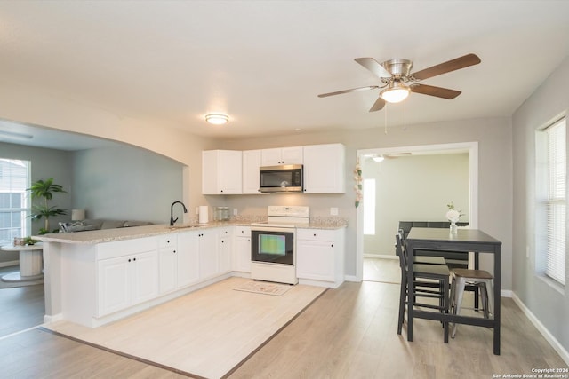 kitchen featuring white cabinetry, light wood-type flooring, kitchen peninsula, and white electric range oven