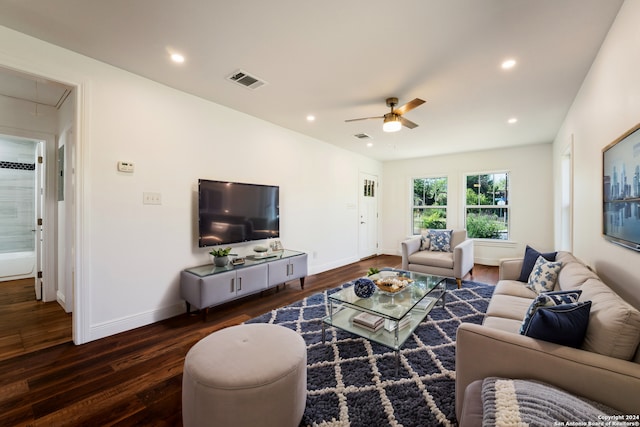 living room featuring dark wood-type flooring and ceiling fan