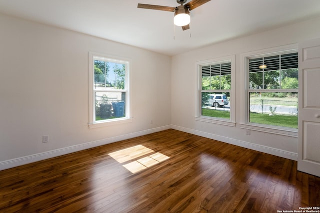 unfurnished room with dark wood-type flooring and ceiling fan