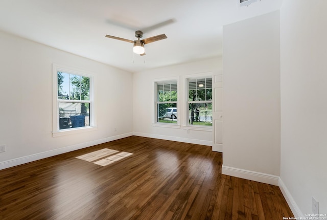 empty room with dark hardwood / wood-style flooring and ceiling fan