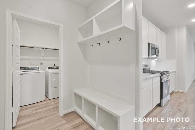 mudroom featuring light hardwood / wood-style flooring and washer and clothes dryer