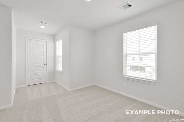 empty room featuring light colored carpet