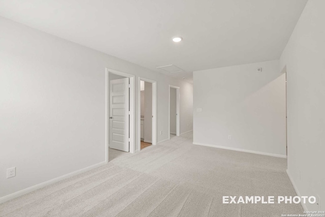 spare room featuring light colored carpet