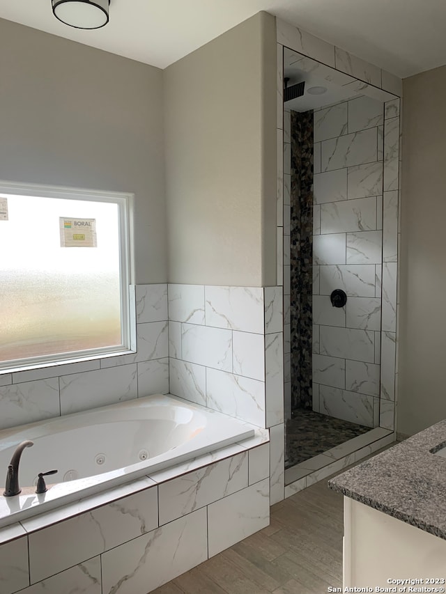 bathroom with plus walk in shower and wood-type flooring