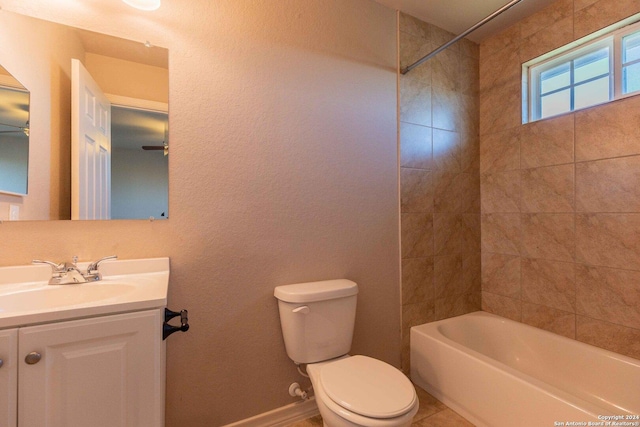 full bathroom featuring vanity, tiled shower / bath combo, and toilet