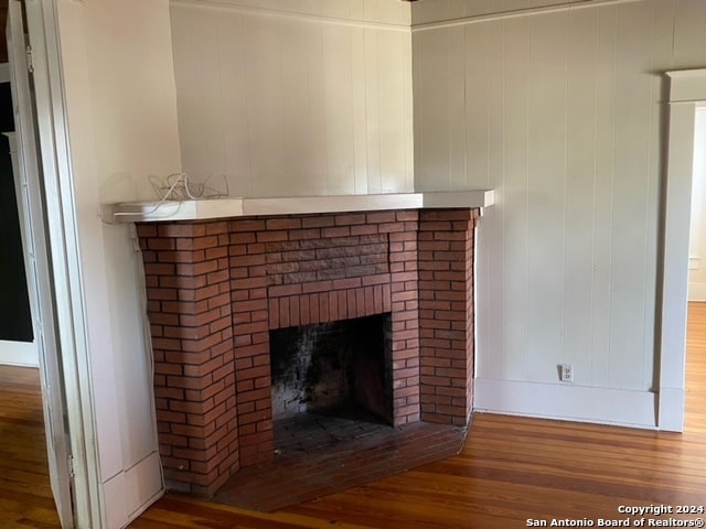 details featuring a fireplace and wood-type flooring