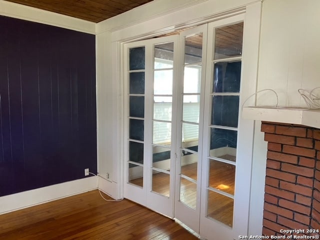 entryway with wooden ceiling, french doors, and dark wood-type flooring